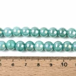 Kép 4/4 - Üveggyöngy - gyöngyházfényű, irizáló, kerek, türkiz, 8x7,5 mm (10db)